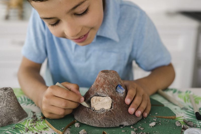 Featuring two ways to explore in one dynamic kit, this volcano surprise will have young scientists bursting with excitement! First, set the pieces in the tray of water to make the volcano erupt and sit back to enjoy the show. Then get to work digging out all the fascinating artifacts unearthed by the eruption, just like in real life. Dinosaur fossils…gems…what will you discover?Download InstructionsAge Recommendation: Ages 8 and up